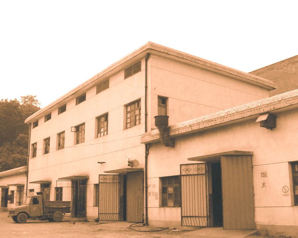 Early factory building representing CMC Electric business roots in 1988