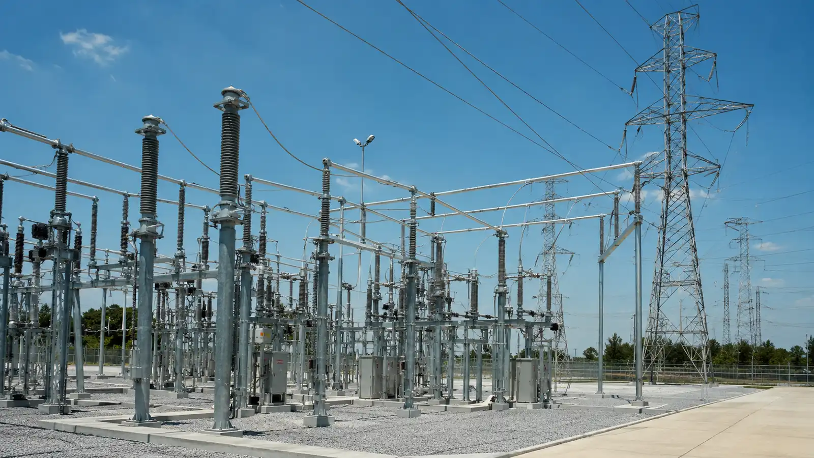 Power utility substation and transmission lines representing CMC Electric's solutions for grid distribution projects